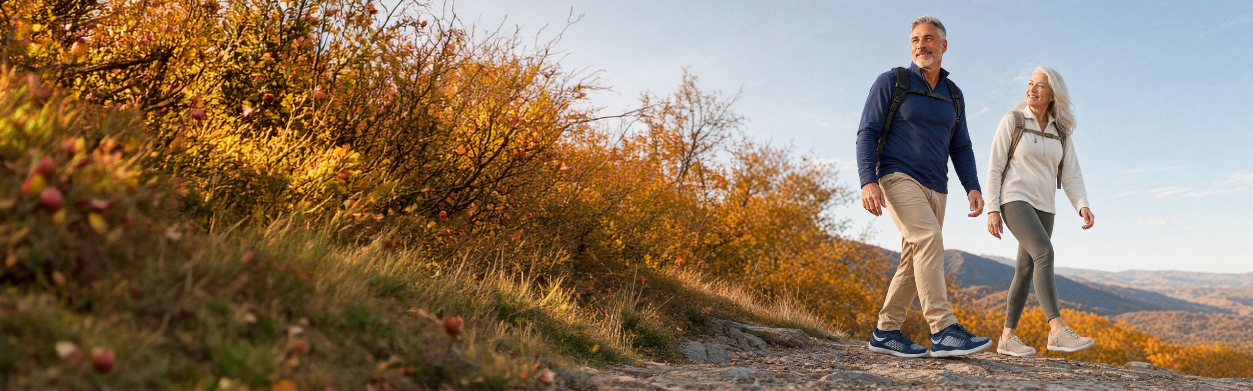 Couple hiking on an autumn mountain trail wearing Hike Footwear barefoot shoes